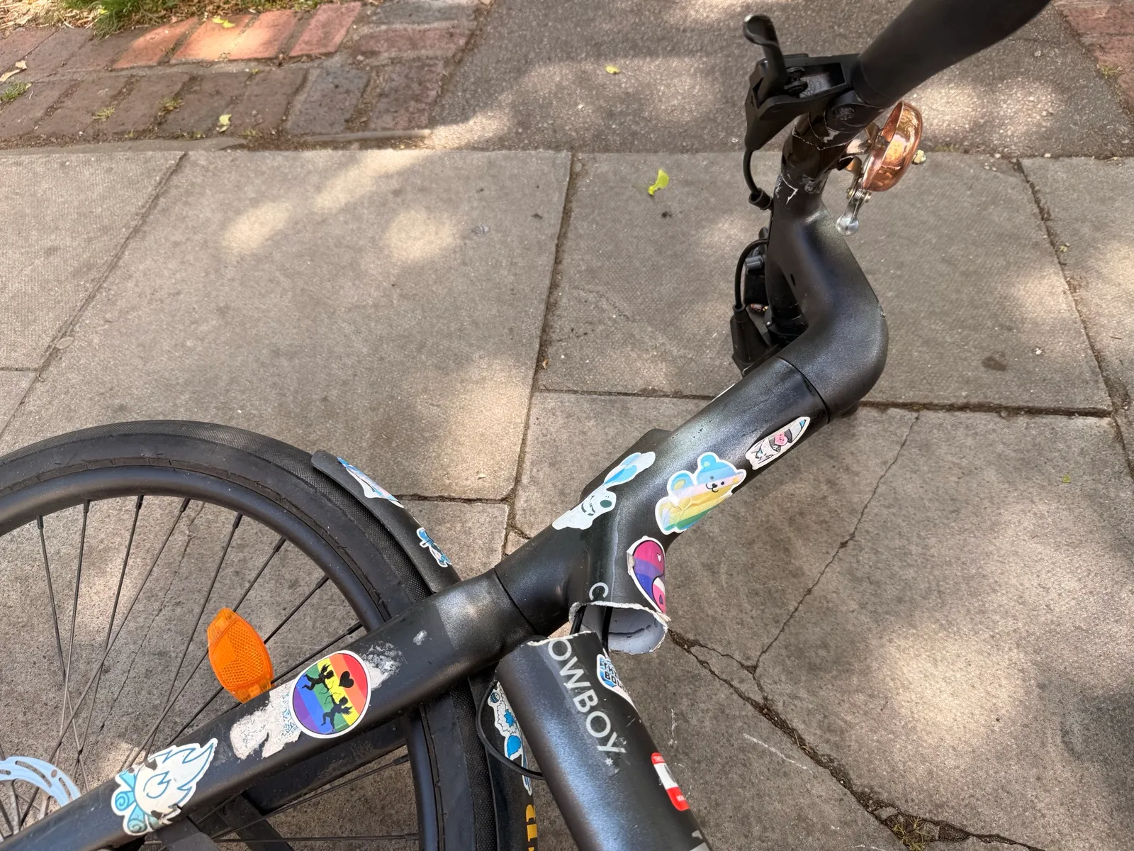 Close-up of a Cowboy C4 ST frame snapped through at the headtube, on a London pavement.